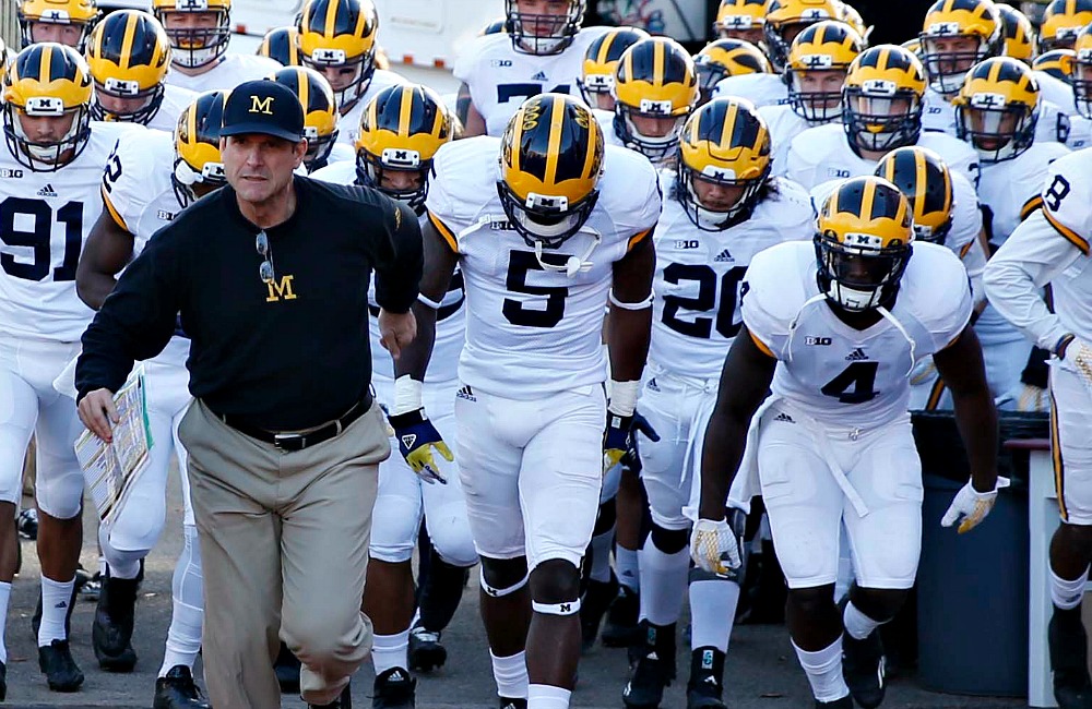 Nov 14, 2015; Bloomington, IN, USA; Michigan Wolverines coach Jim Harbaugh leads his team onto the field before the game against the Indiana Hoosiers  at Memorial Stadium. Mandatory Credit: Brian Spurlock-USA TODAY Sports